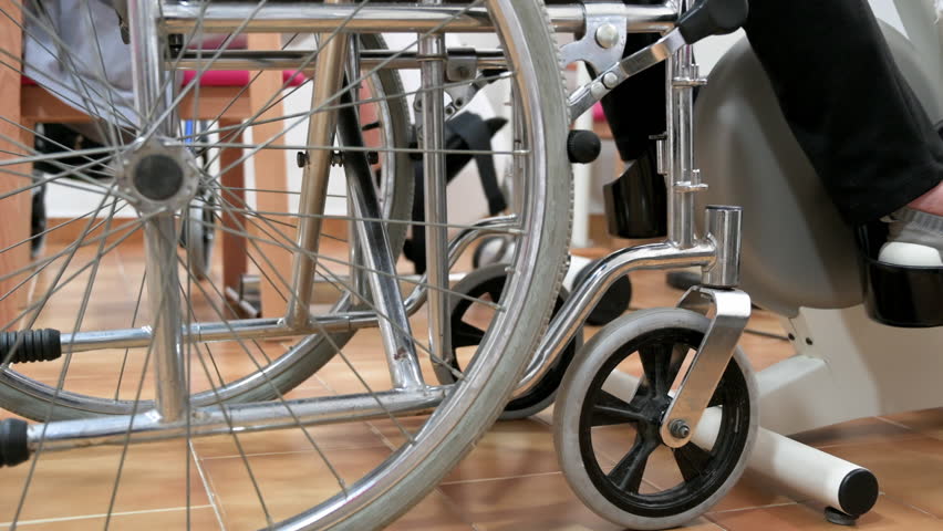 An unrecognizable elderly woman does pedal exercises from wheel chair at hospital. High quality photo. | Shutterstock HD Video #1105514459