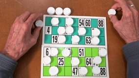 Close up of a senior man playing bingo at Nursing home. leisure game, support, assisted living, and retirement. High quality 4k footage - Powered by Shutterstock - Get 15% off with code: PIKWIZARD15