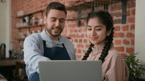 Diverse smiling waiter manager discussing working schedule on laptop cafe employees man woman looking computer screen developing new work strategy talking about business plan restaurant staff meeting - Powered by Shutterstock - Get 15% off with code: PIKWIZARD15