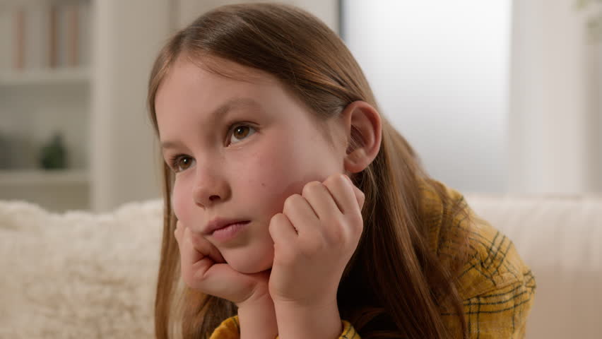 Close-up unhappy bored punished caucasian kid girl feeling sad boredom at home alone lonely frustrated disappointed offended child schoolgirl boring lifestyle concept thinking about problems at school | Shutterstock HD Video #1105515657