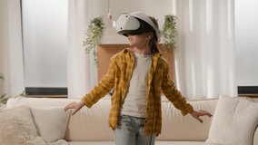Funny happy kid girl playing online video 3d game using virtual reality headset child schoolgirl play in vr glasses at home in living room explore cyberspace world metaverse innovative technology AR - Powered by Shutterstock - Get 15% off with code: PIKWIZARD15