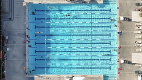Aerial footage of the Tennis and Swim center in Calabasas, California, USA. People enjoying pool facilities while swimming as seen from above. High quality 4k footage