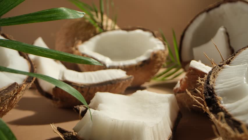 Super slow motion zoom in shot of a lot of dried coconut cut in slices with different sizes. Water dropping slowly into a half of dried coconut Royalty-Free Stock Footage #1105518521