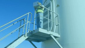 Animation of statistical data processing against male engineer using laptop near a windmill. Business data and renewable energy technology concept - Powered by Shutterstock - Get 15% off with code: PIKWIZARD15