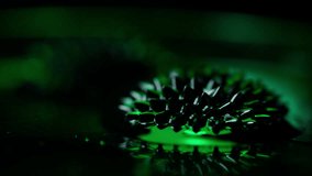 A video of a ferrofluid magnetic phenomenon with the green colored shades