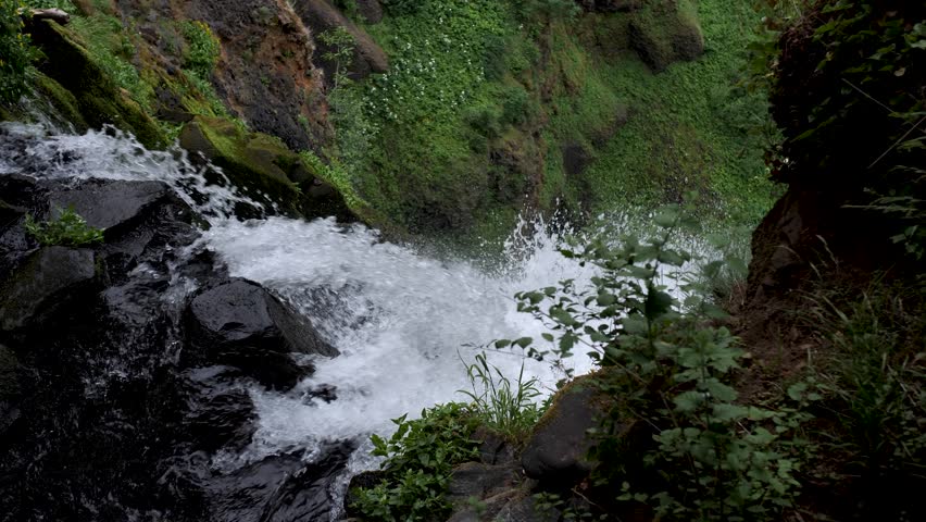 Beautiful close up of water falling down a steep slope creating a beautiful waterfall.