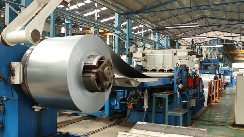 Metal sheet or steel sheet rolling and cutting in a automated machine.