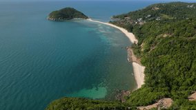 Ko Phangan, Thailand: Dramatic aerial drone video of the Haad Mae beach and island in the Koh Pha Ngan island in the gulf of Thailand in Southeast Asia. Shot with a tilt up motion. 