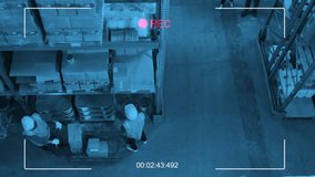 Top view security camera shot of four workers in uniforms and hard hats working in warehouse - Powered by Shutterstock - Get 15% off with code: PIKWIZARD15