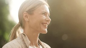 Portrait of confident mature blond woman looking ahead and exhaling fresh air taking deep breath and reducing stress after work at park Successful businesswoman resting for peaceful mind outdoors - Powered by Shutterstock - Get 15% off with code: PIKWIZARD15