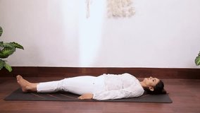 Video of woman performing Ardha Halasana  Uttanpadasana Variation (3) which helps to strengthen the legs
