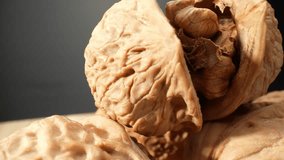 Macro lens unveils the fascinating world within walnuts, showcasing their intricate labyrinth-like structures and earthy tones. Grain and food concept. Walnuts background. 4K HDR
