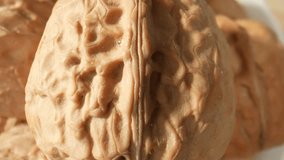 Through the lens of a macro camera, delve into the fascinating world of walnuts, marvel at their knotty textures, and immerse yourself in the irresistible allure of these nature's gems. 4K UHD

