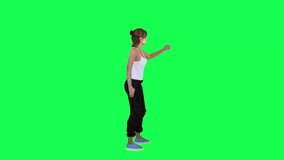 Beautiful young woman painting on wall from left angle on green screen