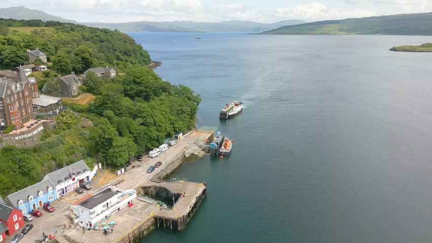 This is an aerial drone shot of Tobermory. a small harbour town on the isle of Mull, the fourth largest island of Great Britain. from here you can take the ferry back to the main land. Royalty-Free Stock Footage #1105541865