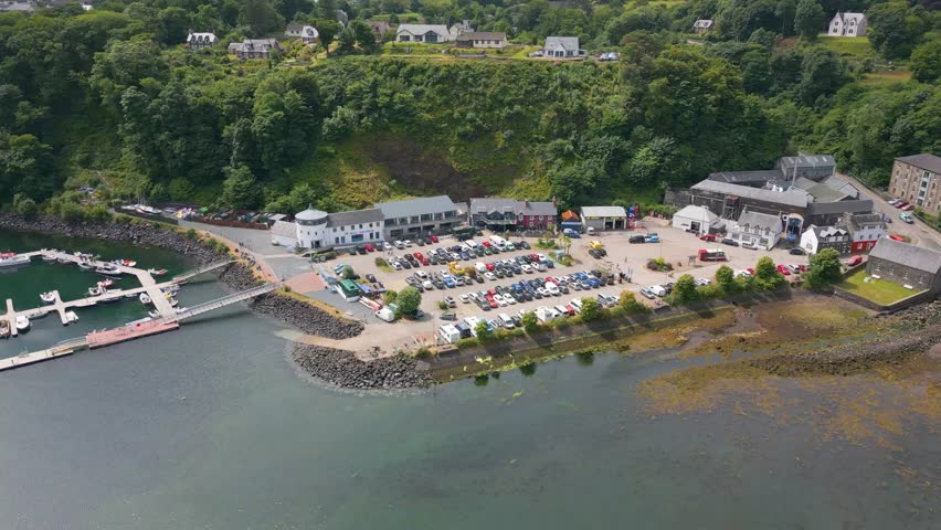 This is an aerial drone shot of Tobermory. a small harbour town on the isle of Mull, the fourth largest island of Great Britain. from here you can take the ferry back to the main land. Royalty-Free Stock Footage #1105541867