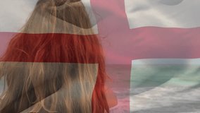 Animation of flag of england waving over beautiful smiling biracial woman standing at beach. Digital composite, multiple exposure, vacation, leisure, freedom and patriotism concept. - Powered by Shutterstock - Get 15% off with code: PIKWIZARD15