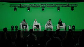 GREEN SCREEN CHROMA KEY Group of 4 experts sitting on stage, answering audience questions during the conference  - Powered by Shutterstock - Get 15% off with code: PIKWIZARD15