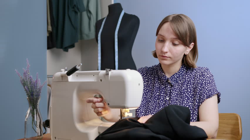 Caucasian man kiss young european woman while she sew his jacket