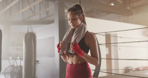 Animation of data processing over caucasian woman in boxing gym. Sports, competition, exercise and data processing concept digitally generated video.