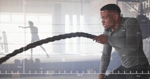 Animation of data processing over african american man exercising with ropes in gym. Sports, competition, exercise and data processing concept digitally generated video.
