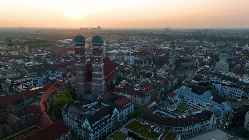 Aerial view of Munich City at sunrise, Cathedral Church of Frauenkirche. Munich skyline panoramic. Germany Royalty-Free Stock Footage #1105549059
