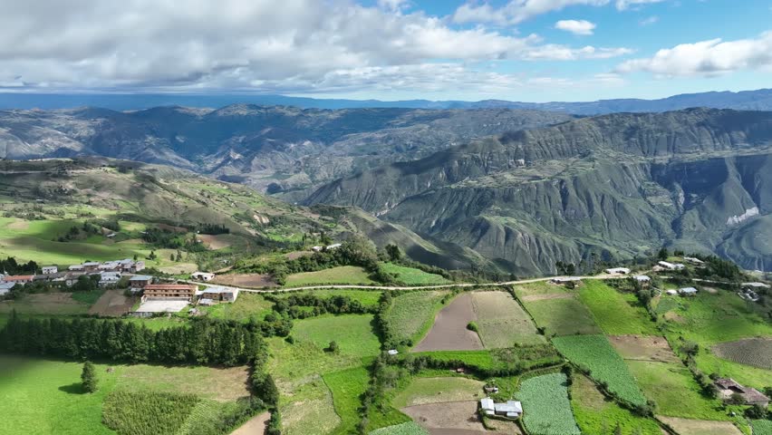 Aerial view of mountains, grasslands and road in the Andes, Andean or Sierra geographical region of the Peru that extends from north to south through the Cordillera de los andes Royalty-Free Stock Footage #1105552265