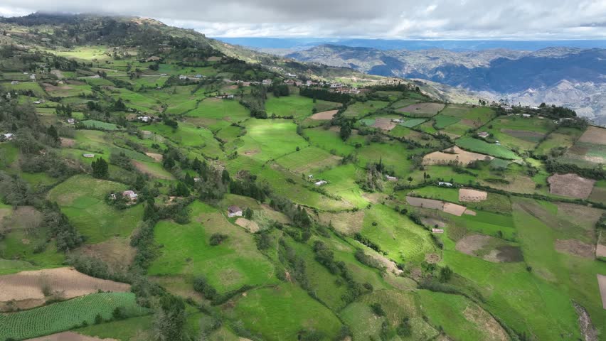 Aerial view of mountains, grasslands and small townin the Andes, Andean or Sierra geographical region of the Peru that extends from north to south through the Cordillera de los andes. Royalty-Free Stock Footage #1105552279