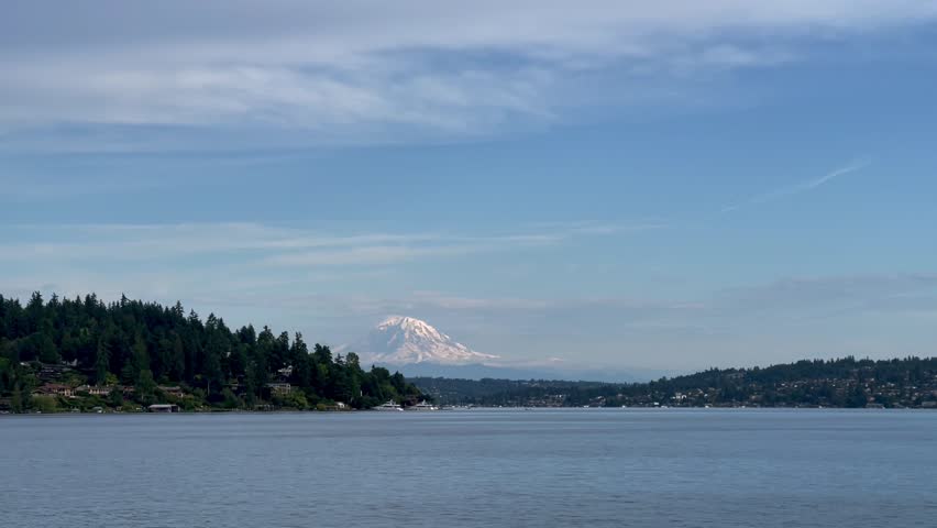 Epic Mount Rainier view Over Lake Washington From Seaward Park in Seattle, Washington USA on bright spring summer day. Explore travel background wallpaper beauty pacific northwest perfection blue Royalty-Free Stock Footage #1105557473