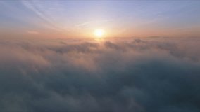 Amazing timelapse of golden fluffy clouds moving softly on sky and golden sun shining through lightweight clouds with beautiful rays and lens flare. Flying through heavenly beautiful sunny cloudscape