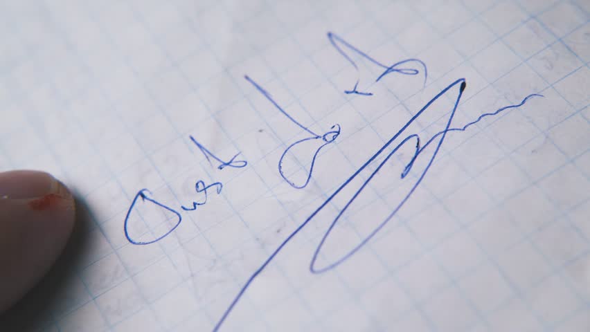 nervous man holds modern blue pen above words JUST DO IT on checkered paper sheet extreme close view