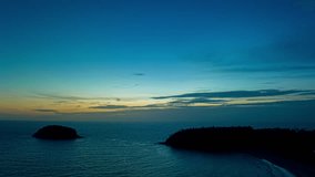
Aerial hyperlapse view beautiful blue sky above the ocean at Karon beach.
The setting sun creates a stunning contrast between the deep blue of 
the sky and the colorful hues of the clouds.
