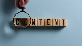 Wooden cubes with the word CONTENT on a blue table. Cubes with black letters. - Powered by Shutterstock - Get 15% off with code: PIKWIZARD15