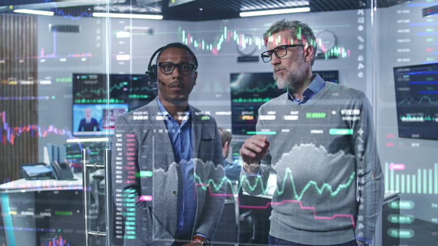 Multiracial financial analysts look on computer generated virtual 3D real-time stocks on glass wall, analyze business strategy in investment bank. Computers and big digital screens on background. Royalty-Free Stock Footage #1105565909