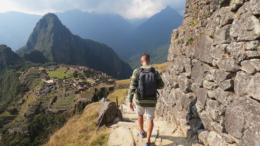 4k man walking down stairs lost city in Cusco, Machu pichu city in Peru. Royalty-Free Stock Footage #1105568391