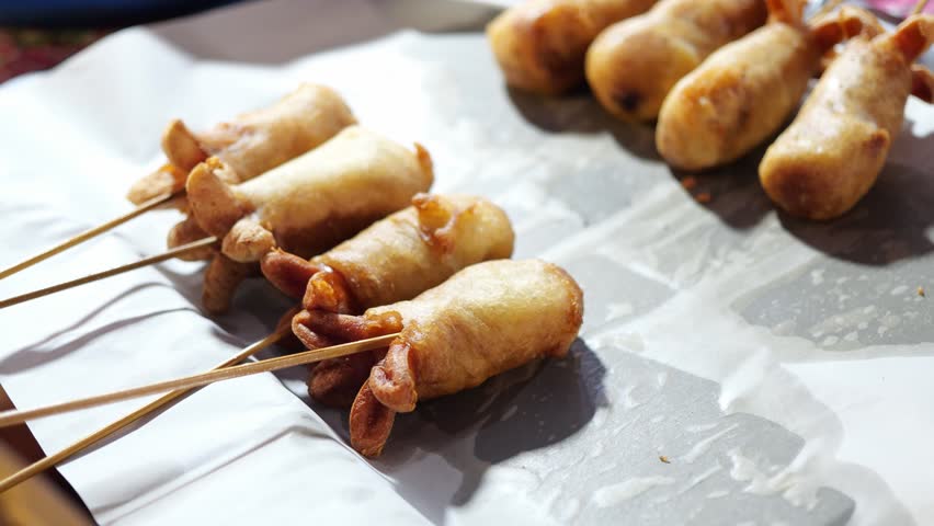 Sausage fried pastry Thai traditional fried snacks It is a street food that can be found in the market Royalty-Free Stock Footage #1105570887