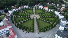 Drone shot, showing the historical classic circus square of Putbus town with white houses, located on the Rügen Island in Germany
