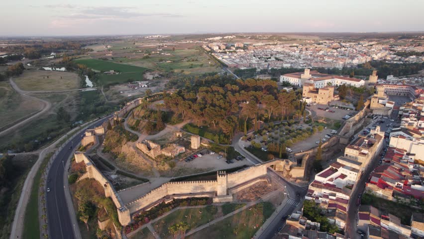 Enchanting birds-eye shot of Alcazaba, landscape backdrop. golden hour. Badajoz, Spain