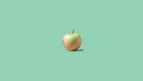 Stop motion Cut and whole Apple appear and disappear on pastel green background. High quality video 4K. Detailed stop motion video. Background or wallpaper in food and drinks videos.