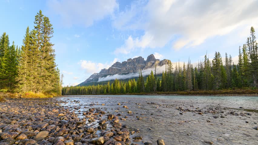 Time lapse of Scenery of sunrise over Castle mountain and bow river flowing in the morning at Banff national park, Alberta, Canada