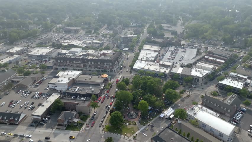 Downtown Plymouth, Michigan with drone video moving in wide shot.