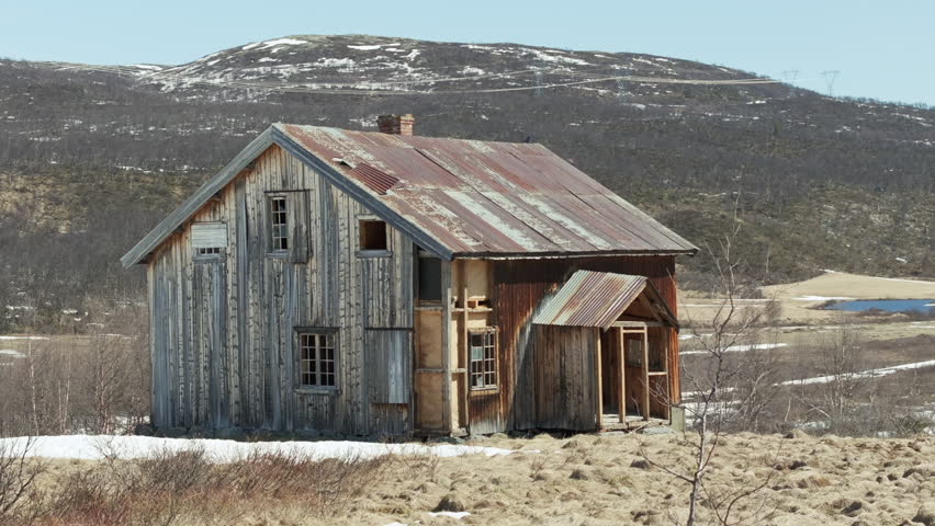Old abandoned homestead farm house on remote Norway mountain; drone orbit