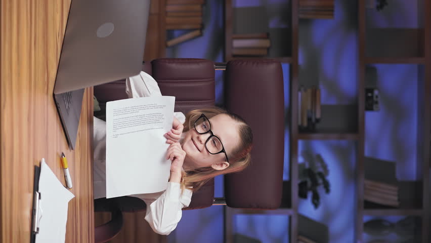 Little business lady feeling pissed off after reading papers about company debts and tearing documents. Formally dressed irritated kid feeling stress and despair. Vertical video.