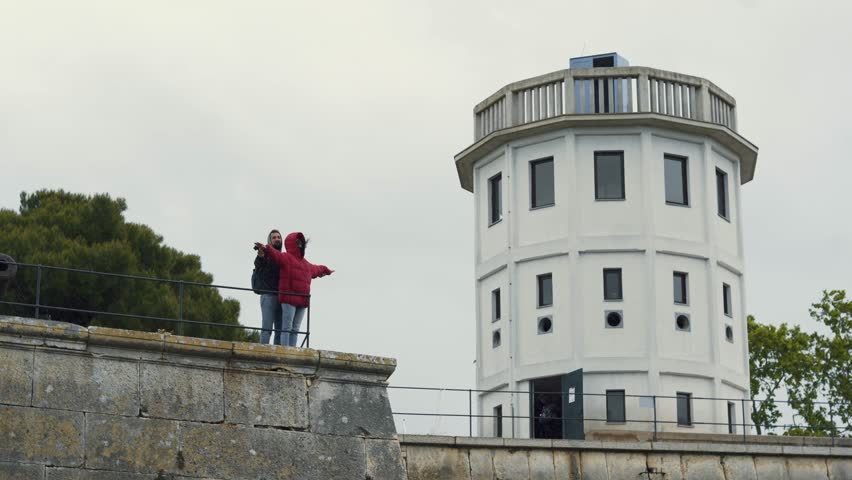 Young, couple standing in titanic pose and enjoying beautiful view of old city , Croatia 