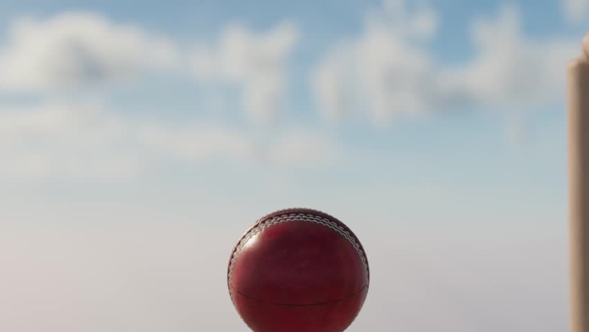 An ultra motion close up of a red leather stitched cricket ball hitting wooden wickets with dirt particles emanating from the impact Royalty-Free Stock Footage #1105581237