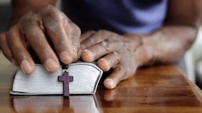 man praying to God with hand on bible with people stock video stock footage