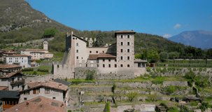 Tenno Castle perched on rocky hillside in Trentino, northern Italy. Aerial orbiting
