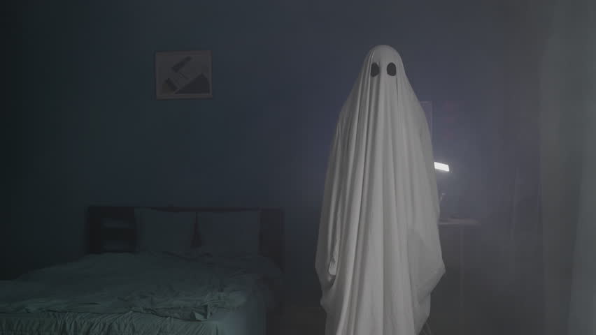 Scary ghost on a dark room in the fog. An evil spirit with a covered sheet. Halloween concept. Royalty-Free Stock Footage #1105584755