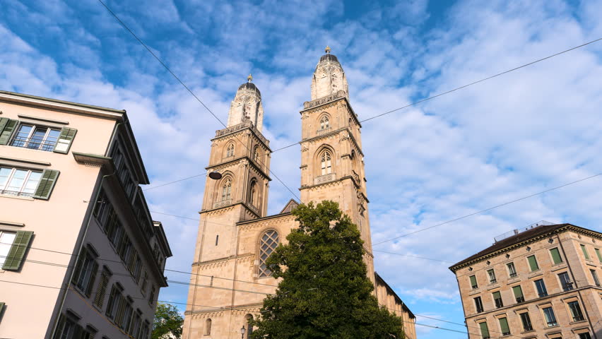 Zoom in time lapse of two bell towers of the Grossmunster reformed church in Zurich, Switzerland