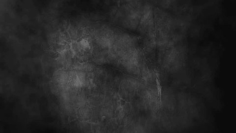Scary, dark, smoke-filled horror background with a textured wall. Room is engulfed in darkness, with only faint, flickering light sources casting eerie shadows.の動画素材